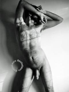 künstlerische Aktaufnahme eines Mannes mit verschränkten Armen vor Gesicht